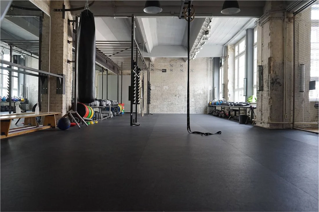 Strength room with punching bag, kettlebells and battle rope at Lokahi Loft Berlin