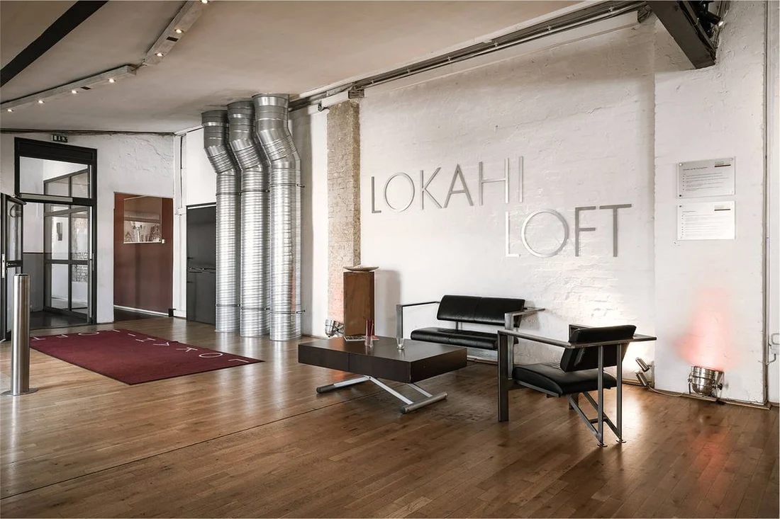 Reception area with the Lokahi Loft sign and lounge furniture