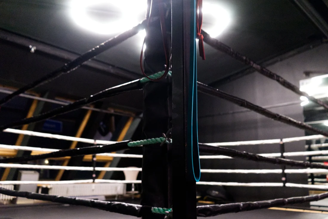 Close-up of the boxing ring corner post with hand wraps at Lokahi Loft Berlin