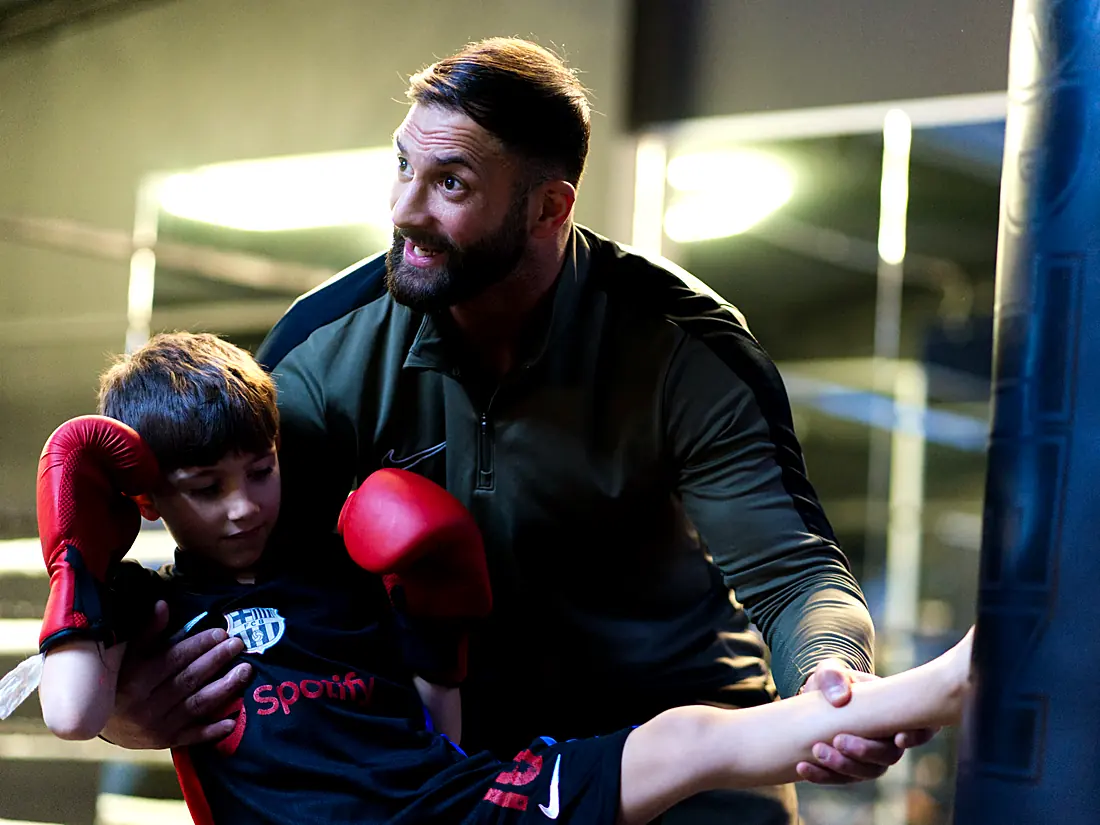 Trainer coaching a young athlete during boxing training at Lokahi Loft Berlin